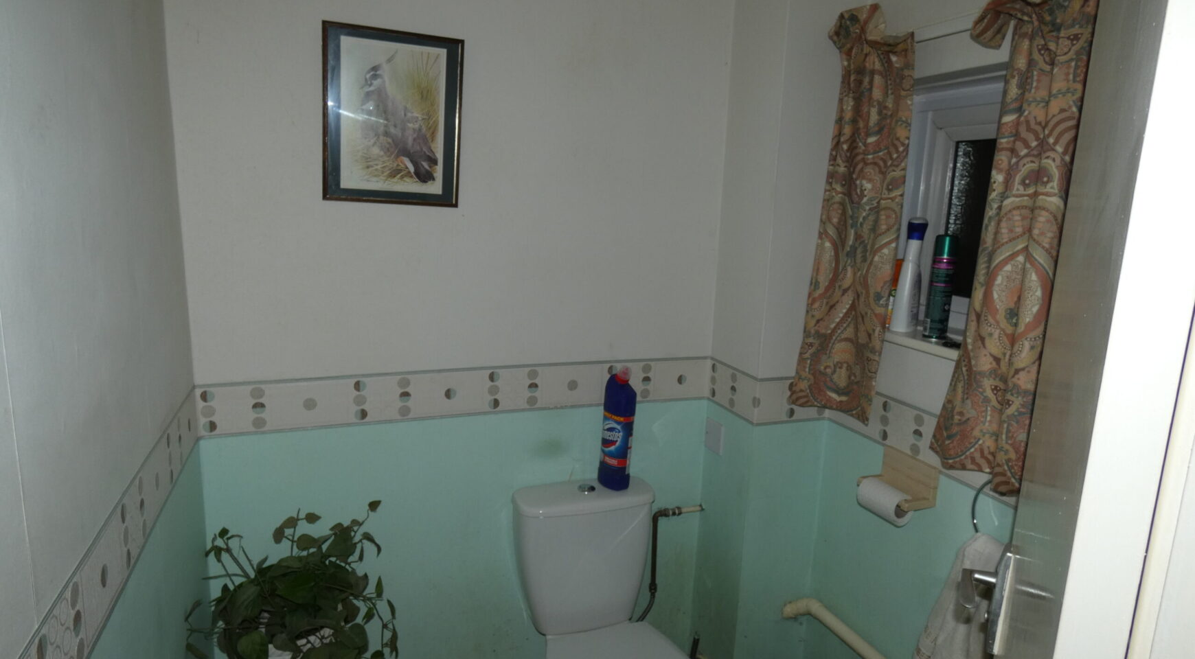 Bathroom with white walls and toilet